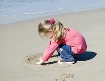 Little Beautiful Girl Draws On Sand Royalty Free Stock Photo Little Beautiful Girl Draws On Sand Royalty Free Stock Photo