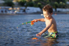Little Boy And Toy Fishing Pole Stock Photography