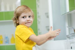 Little boy in a bathroom washes hand with soap stock images Little boy in a bathroom washes hand with soap stock images