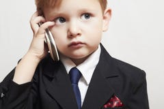 Little boy in business suit with cell phone. handsome child. fashionable kid