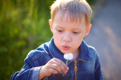 Little boy in cap playing outdoors in summer on a Sunny warm day, grass, greens, nature stock photo Little boy in cap playing outdoors in summer on a Sunny warm day, grass, greens, nature stock photo