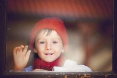 Little Boy, Child Behind The Window, Wearing Hat And Scarf Stock Image Little Boy, Child Behind The Window, Wearing Hat And Scarf Stock Image