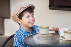 Little boy drinking milkshake in cafe stock image Little boy drinking milkshake in cafe stock image