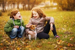 Little boy and girl with her puppy jack russell in autumn outdoo royalty free stock photography Little boy and girl with her puppy jack russell in autumn outdoo royalty free stock photography