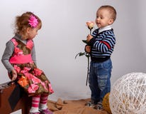 Little boy gives a girl a rose, isolated on white stock photography Little boy gives a girl a rose, isolated on white stock photography