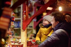 Little boy and his father having wonderful time on Xmas market stock photos Little boy and his father having wonderful time on Xmas market stock photos