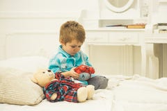 Little boy playing with bear. happy family and childrens day. child play toys. happy childhood. Care and development stock image Little boy playing with bear. happy family and childrens day. child play toys. happy childhood. Care and development stock image