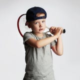 Little Boy Playing Tennis. Sport kids.Child with Tennis Racket royalty free stock images Little Boy Playing Tennis. Sport kids.Child with Tennis Racket royalty free stock images