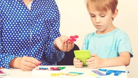 Little Boy Plays Logical Game At The Lesson Of A Psychologist. Smart Kid With Teacher Learning At Preschool Classroom. Education A Royalty Free Stock Photography