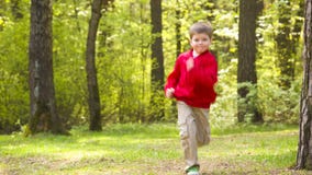 Little boy runs park
