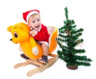 Little boy in Santa Claus suit riding a toy cat Royalty Free Stock Images Little boy in Santa Claus suit riding a toy cat Royalty Free Stock Images