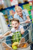Little Boy Sits In The Shopping Trolley With Watermelon Stock Photography Little Boy Sits In The Shopping Trolley With Watermelon Stock Photography