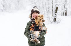 Little boy and small doggy in winter park. Royalty Free Stock Photography Little boy and small doggy in winter park. Royalty Free Stock Photography