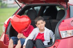 Little boys giving balloon heart to his mother love stock photos Little boys giving balloon heart to his mother love stock photos