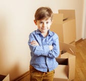 Little Cute Boy In Empty Room, Remoove To New House. Home Alone Emong Boxes Royalty Free Stock Image