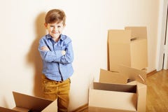 Little Cute Boy In Empty Room, Remoove To New House. Home Alone Emong Boxes Stock Photos