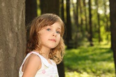 Little cute girl leaning against tree Royalty Free Stock Images Little cute girl leaning against tree Royalty Free Stock Images