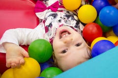 Little Cute Smile Girl Plays In Balls For A Dry Pool. Play Room. Happiness Royalty Free Stock Image