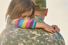 Little female child is hugging a soldier. stock photography Little female child is hugging a soldier. stock photography