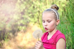 Little girl blowing a dandelion royalty free stock photo Little girl blowing a dandelion royalty free stock photo