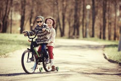 Little girl and boy riding on bicycle together Stock Photo Little girl and boy riding on bicycle together Stock Photo