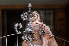 Little girl decorates the gate of the house royalty free stock photo Little girl decorates the gate of the house royalty free stock photo