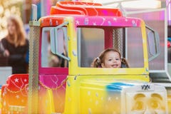 Little girl enjoying fun fair ride, amusement park Royalty Free Stock Photos Little girl enjoying fun fair ride, amusement park Royalty Free Stock Photos