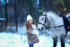 Little girl feeding little horse pony winter. Stock Images Little girl feeding little horse pony winter. Stock Images
