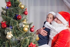Little girl at the hands of Santa Claus royalty free stock photos Little girl at the hands of Santa Claus royalty free stock photos