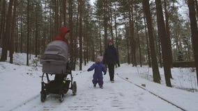 Little girl having fun together with mother and grandmother on winter day stock footage Little girl having fun together with mother and grandmother on winter day stock footage