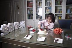 Little girl help prepare birthday party
