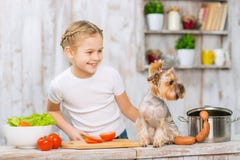 Little girl and her dog on the kitchen table. royalty free stock photography Little girl and her dog on the kitchen table. royalty free stock photography