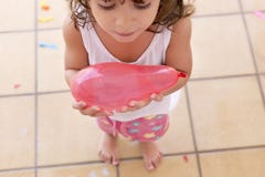 Little girl holding a water ballon royalty free stock images Little girl holding a water ballon royalty free stock images