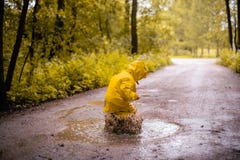 Little girl jumping fun in a dirty puddle Stock Images Little girl jumping fun in a dirty puddle Stock Images