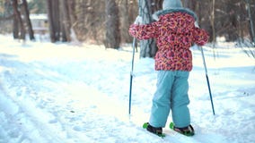 A little girl is learning cross country skiing