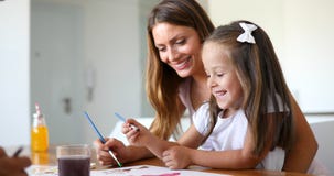 Little girl painting with her mother at home royalty free stock image Little girl painting with her mother at home royalty free stock image