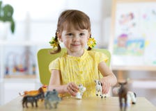 Little girl playing with animal toys stock photography Little girl playing with animal toys stock photography