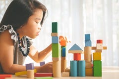 Little girl playing with construction toy blocks building a tower royalty free stock image Little girl playing with construction toy blocks building a tower royalty free stock image
