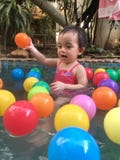 Little girl playing in hot spring pool