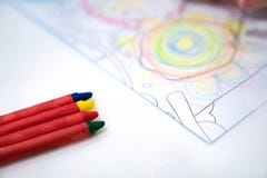 Little girl plays and learns to coloring Crayon on the paper in the ice-cream restaurant., Bangkok, Thailand royalty free stock photography Little girl plays and learns to coloring Crayon on the paper in the ice-cream restaurant., Bangkok, Thailand royalty free stock photography