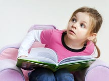 Little Girl Reading A Book And Looking Up Stock Photos Little Girl Reading A Book And Looking Up Stock Photos