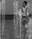 Little girl plays in water fountain jet Stock Photography Little girl plays in water fountain jet Stock Photography