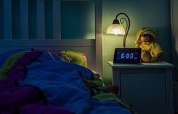 Little girl sleeping in bed - Alarm clock at 6 am in the morning. royalty free stock photos Little girl sleeping in bed - Alarm clock at 6 am in the morning. royalty free stock photos
