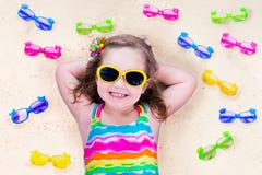 Little girl with sun glasses on a beach royalty free stock photo Little girl with sun glasses on a beach royalty free stock photo