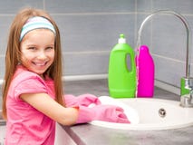Little Girl Washing The Dishes Stock Images