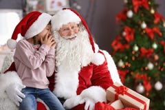 Little Girl Whispering In Authentic Santa Claus` Stock Images Little Girl Whispering In Authentic Santa Claus` Stock Images