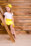 Little girl with wreath sitting on stairs of ladder royalty free stock photography Little girl with wreath sitting on stairs of ladder royalty free stock photography