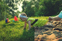 A little girl in a yellow dress crawls on grass royalty free stock photos A little girl in a yellow dress crawls on grass royalty free stock photos