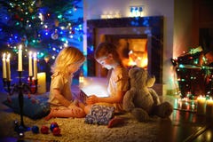 Little Girls Opening A Magical Christmas Gift Royalty Free Stock Photo Little Girls Opening A Magical Christmas Gift Royalty Free Stock Photo