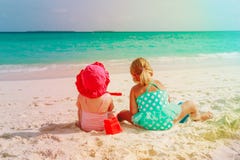 Little girls play with sand on beach Royalty Free Stock Photos Little girls play with sand on beach Royalty Free Stock Photos